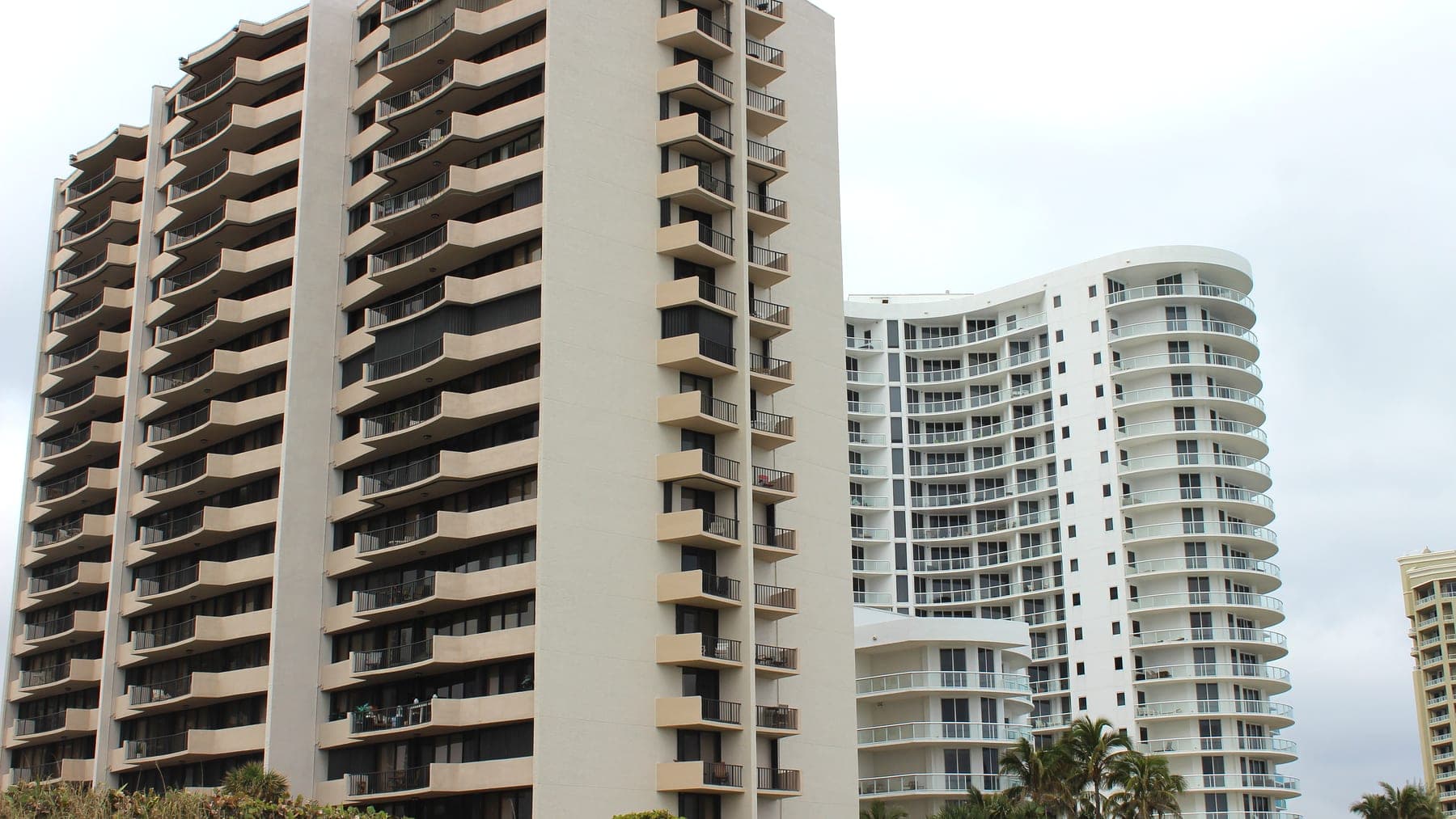 The Cote D'Azur tower seen from the dune line, with neighboring oceanfront buildings behind