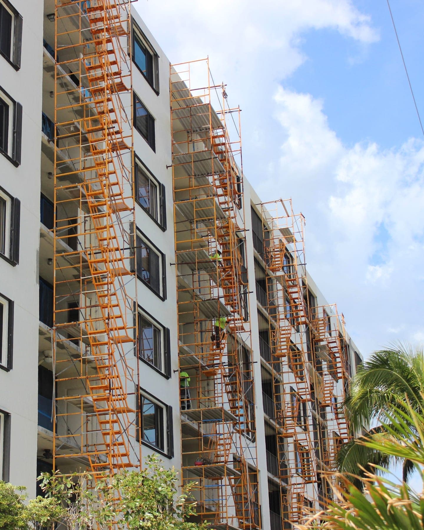 Scaffolding erected across a condominium facade during exterior concrete and stucco repair