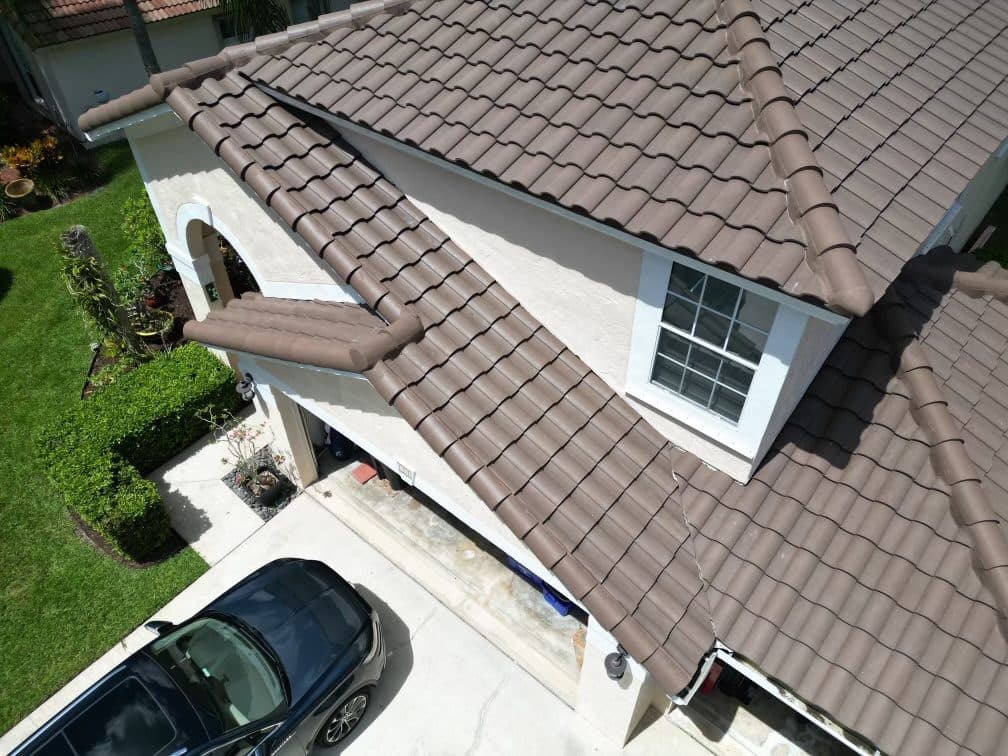 Close view of a barrel tile roof and adjoining entryway on a single-family home